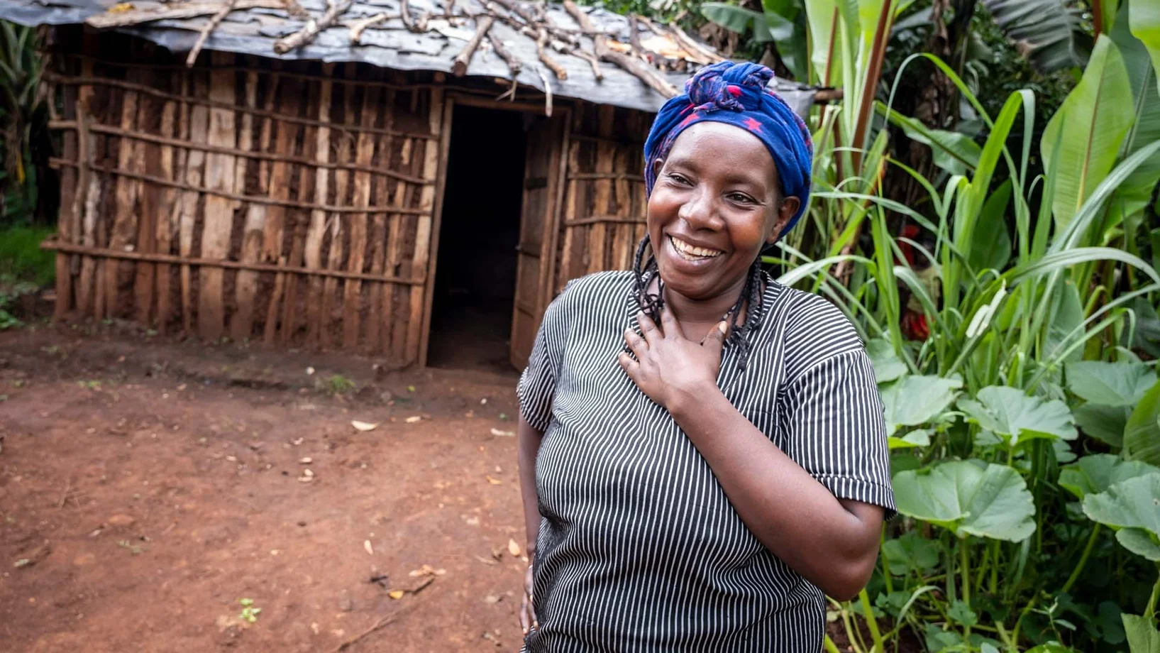 Fikre Demeke in front of her new house | Foundation Menschen für Menschen Fikre Demeke laughing in front of her new house